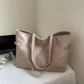 Large khaki suede tote bag for women showing a spacious interior and metal buckle side details - Light Khaki