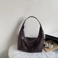 Detail view of deep brown hobo bag with vintage leather texture and zipper closure - Brown