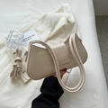 Detail of beige PU leather shoulder bag featuring a magnetic flap and adjustable strap - Off White