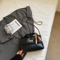 Detail of black wrinkled leather bag with gold chain strap and wooden bead charm decor - Black With Pendant