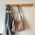 Retro dusty pink suede hobo bag with fringe detail and black leather strap on wooden hook - Khaki No Pendant