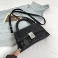 Chic black snakeskin textured crossbody bag with silver twist lock and handle - Black