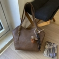 Detail of coffee brown tote bag with retro pleated texture and plush bear charm decoration - With Charm / Brown