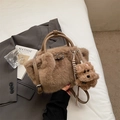 Detailed shot of brown plush bucket bag with leather handle and cute puppy charm - Khaki (With Charm)