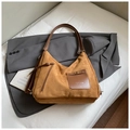 Detailed macro view of brown faux suede texture and vertical tassel zipper on shoulder bag - Brown No Pendant