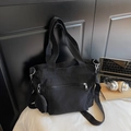Detail view of black canvas tote bag with front zipper pocket and round pouch attachment - Black