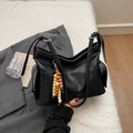 Black vegan leather dumpling bag with side pockets and ethnic beaded pendant accessory - Black (With Bead Pendant)