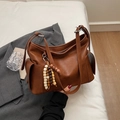 Minimalist brown dumpling bag in caramel leather with wooden bead charm detail - Brown (With Bead Pendant)