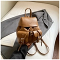 Close-up of vintage brown PU leather backpack with flip-top and metal buckle detail - Brown