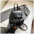 Close-up of black PU leather backpack with silver buckles on a grey blazer background - Black