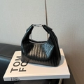 Elegant black woven leather Hobo bag with silver metal buckle on a fashion book - Black without Pendant