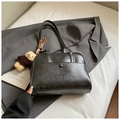 Detail view of black PU leather Boston bag with ZSKERT embossing and cute plush bear charm - Black With Pendant