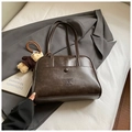 Detail of dark brown PU leather Boston bag with plush bear charm and front pocket - Coffee With Pendant