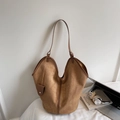 Brown suede tote bag with mini pouch detail on white bedding background with artsy decor - Khaki