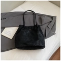 Minimalist black matte leather tote bag with gold COIN MOD logo on grey blazer backdrop - No Pendant / Black