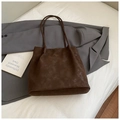 Deep brown suede tote bag with minimalist gold logo on a grey business blazer - No Pendant / Brown