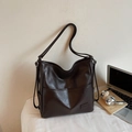 Versatile dark brown PU leather backpack tote with front pocket in a desk lifestyle setting - Brown