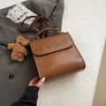 Vintage brown leather backpack with embossed letters and a cute plush bear charm - Yellowish Brown With Pendant