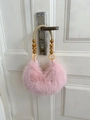 Detail of pink faux fur bag with woven rope handle and dark brown wooden beads - Pink