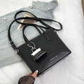 Minimalist black bucket bag with荔枝纹理 leather texture and adjustable strap - Black