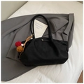Detailansicht der schwarzen Wildleder-Tote Bag mit Metallstab und buntem Plüsch-Anhänger - Schwarz mit Anhänger