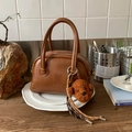 Brown vintage bowling bag with dual handles and cute plush bear charm accessory - With Charm / Brown