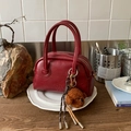 Deep reddish-brown faux leather bowling bag with vintage texture and plush bear charm - With Charm / Burgundy