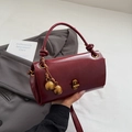 Retro burgundy leather handbag with golden sphere tassels and sleek turn-lock closure - With Charm / Red