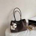 Close-up of brown matte tote bag with laptop, headphones, and a white plush dog pendant - Coffee (With Pendant)