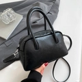 Detail of black PU leather Boston bag with vintage texture and metallic side clips - Black without Pendant
