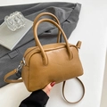Detailed view of tan Boston handbag with soft faux leather texture and silver zipper detail - Brown No Pendant