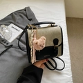 Detalle de mochila retro de lona y cuero con un lindo colgante de oso de peluche rosa - Beige y Negro