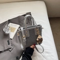 Gray embossed leather bucket bag with top handles and a brown furry monster charm - Gray