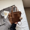 Brown leopard print suede bucket bag with round handles and plush monster charm decoration - Brown
