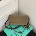 Detail of khaki suede crossbody bag with vintage wooden bead charm and brown leather strap - Mocha