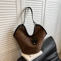 Close-up of leopard print suede tote bag featuring black leather trim and soft texture - Black Leopard
