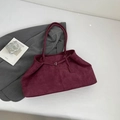 Deep burgundy suede tote bag with dual straps and metallic buckle detail on white backdrop - Red