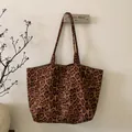 Detailopname van luipaardprint tote bag met schouderbanden aan een wandhaakje - Grote bruine luipaardprint
