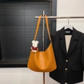 Orange caramel leather hobo tote bag with plush charm on display for autumn style - With Pendant / Yellow Brown