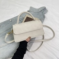 Detail view of white square bag with matte finish and elegant golden metal hooks - Off White