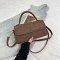 Detail of brown faux leather handbag with gold metal clasp and detachable strap - Brown