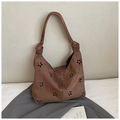 Close-up of brown suede tote bag with intricate floral laser-cut hollow pattern details - Brown