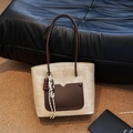 Chic beige woven tote bag with dark brown leather pocket and dual shoulder straps - Oatmeal