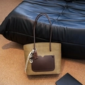 Khaki woven tote bag with dark brown leather pocket and chocolate shaped pendant - Green Brown
