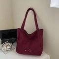 Elegant wine red suede tote bag with metal logo, displayed on a minimalist white desk - Wine Red Without Pendant