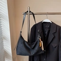 Detail of black suede hobo bag with ethnic wooden and ceramic beaded pendant accessory - Black With Pendant