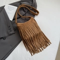 Detailed close-up of brown suede tassel bag with fringe texture and vintage bohemian style - Brown