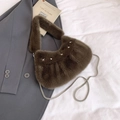 Detailed macro view of a brown plush shoulder bag with silver star studs and metal chain - Brown