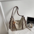 Detailed view of the olive green tote bag featuring wooden bead tassels and leather straps - Beige With Pendant