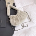 Detailed view of plush beige faux fur shoulder bag with silver snake chain on grey blazer - Off White